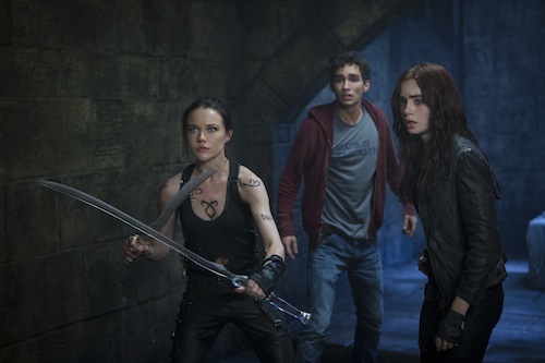 Isabelle Lightwood (Jemima West), Simon (Robert Sheehan) and Clary (Lily Collins) prepare to hold off the demons in Screen Gems THE MORTAL INSTRUMENTS: CITY OF BONES. PHOTO BY: Rafy COPYRIGHT: 2013 Constantin Film International GmbH and Unique Features (TMI) Inc. All rights reserved. ALL IMAGES ARE PROPERTY OF SONY PICTURES ENTERTAINMENT INC. FOR PROMOTIONAL USE ONLY. SALE, DUPLICATION OR TRANSFER OF THIS MATERIAL IS STRICTLY PROHIBITED. Isabelle Lightwood (Jemima West), Simon (Robert Sheehan) and Clary (Lily Collins) prepare to hold off the demons in Screen Gems THE MORTAL INSTRUMENTS: CITY OF BONES. PHOTO BY: Rafy COPYRIGHT: 2013 Constantin Film International GmbH and Unique Features (TMI) Inc. All rights reserved. ALL IMAGES ARE PROPERTY OF SONY PICTURES ENTERTAINMENT INC. FOR PROMOTIONAL USE ONLY. SALE, DUPLICATION OR TRANSFER OF THIS MATERIAL IS STRICTLY PROHIBITED.