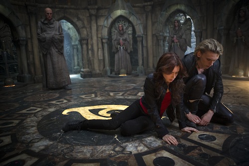 Clary (Lilly Collins) and Jace (Jamie Campbell Bower) look at what Clary wrote while the Brothers were trying to unlock her mind in Screen Gems' fantasy-action THE MORTAL INSTRUMENTS: CITY OF BONES. PHOTO BY:	Rafy COPYRIGHT:	2013 Constantin Film International GmbH and Unique Features (TMI) Inc. All rights reserved. ALL IMAGES ARE PROPERTY OF SONY PICTURES ENTERTAINMENT INC. FOR PROMOTIONAL USE ONLY. SALE, DUPLICATION OR TRANSFER OF THIS MATERIAL IS STRICTLY PROHIBITED.