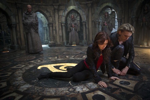Clary (Lilly Collins) and Jace (Jamie Campbell Bower) look at what Clary wrote while the Brothers were trying to unlock her mind in Screen Gems' fantasy-action THE MORTAL INSTRUMENTS: CITY OF BONES. PHOTO BY: Rafy COPYRIGHT: 2013 Constantin Film International GmbH and Unique Features (TMI) Inc. All rights reserved. ALL IMAGES ARE PROPERTY OF SONY PICTURES ENTERTAINMENT INC. FOR PROMOTIONAL USE ONLY. SALE, DUPLICATION OR TRANSFER OF THIS MATERIAL IS STRICTLY PROHIBITED. Clary (Lilly Collins) and Jace (Jamie Campbell Bower) look at what Clary wrote while the Brothers were trying to unlock her mind in Screen Gems' fantasy-action THE MORTAL INSTRUMENTS: CITY OF BONES. PHOTO BY: Rafy COPYRIGHT: 2013 Constantin Film International GmbH and Unique Features (TMI) Inc. All rights reserved. ALL IMAGES ARE PROPERTY OF SONY PICTURES ENTERTAINMENT INC. FOR PROMOTIONAL USE ONLY. SALE, DUPLICATION OR TRANSFER OF THIS MATERIAL IS STRICTLY PROHIBITED.