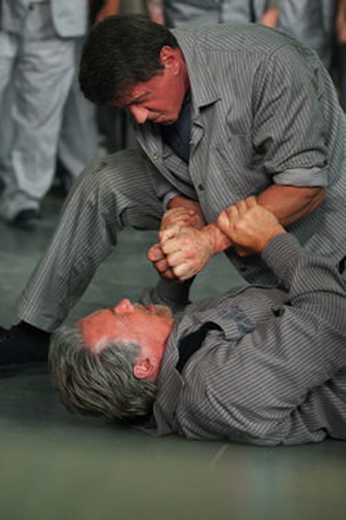 Sylvester Stallone and Arnold Schwarzenegger in Escape Plan. 2013 Summit Entertainment.