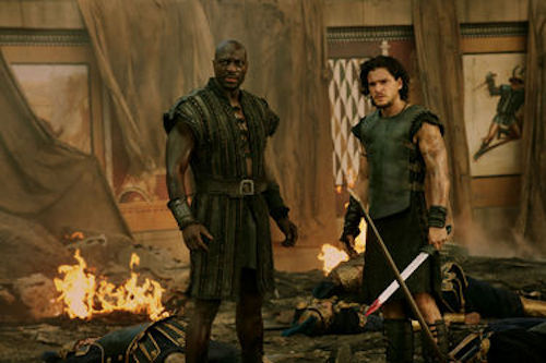 Adewele Akinnouye-Agbaje as Atticus and Kit Harington as Milo in Pompeii. 2014 George Kraychyk / Sony Pictures. Adewele Akinnouye-Agbaje as Atticus and Kit Harington as Milo in Pompeii. 2014 George Kraychyk / Sony Pictures.