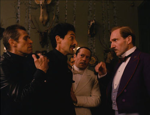 Willem Dafoe as Jopling, Adrien Brody as Dmitri, Mathieu Almaric as Serge and Ralph Fiennes as M. Gustave in The Grand Budapest Hotel. 2014 Fox Seachlight Pictures.