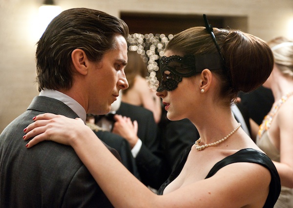 CHRISTIAN BALE as Bruce Wayne and ANNE HATHAWAY as Selina Kyle in Warner Bros. Pictures' action thriller 